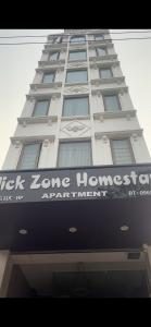 a tall white building with a sign on it at Flick Zone Trung Lực in Lực Hánh
