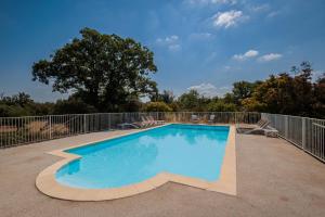 a swimming pool on a patio with a fence at Mas De Baumes in Ferrières-les-Verreries +40 photos