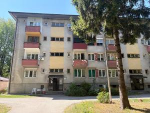 an apartment building with a tree in front of it at Una Mirage in Bihać