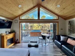 a living room with a couch and a table with chairs at Inside Out Cottage - One With Nature in Crest Park