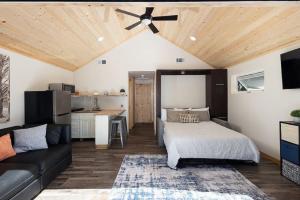 a living room with a bed and a kitchen at Inside Out Cottage - One With Nature in Crest Park +50 photos