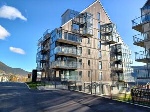 an apartment building with balconies in a parking lot at View Apartments in Åre