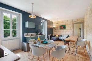 a kitchen and living room with a table and chairs at B&B L'Annexe De Camillac in Bourg-sur-Gironde