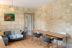 a living room with a table and a couch at B&B L'Annexe De Camillac in Bourg-sur-Gironde +46 photos