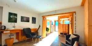 a living room with chairs and a desk in a room at Bio & Reiterhof der Veitenhof - Pferde, Berge, Wellness & Freiheit im Ötztal in Niederthai +69 photos