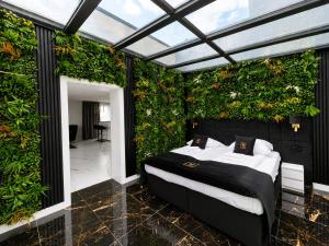 ein Schlafzimmer mit einem Bett und einer grünen Wand in der Unterkunft Hotel Lantier - Basen & Gabinet SPA in Bytom