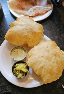 a plate with two plates of food on a table at VIDYA Homestay in Hampi +23 photos