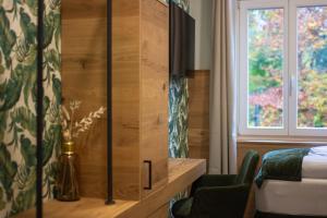 a bedroom with a bed and a cabinet with a window at Gasthof Schloss Hubertus in Erfurt +64 photos
