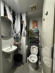 a bathroom with a toilet and a sink at Plumera Mactan Bldg A 108 in Bankal