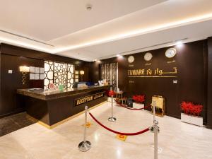 a hotel lobby with a red rope around a counter at توارن للشقق المخدومة - الاقتصادية in Riyadh