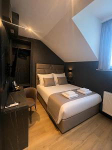 a bedroom with a bed and a desk and a window at Maritime Łeba in Łeba +34 photos