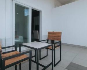 two chairs and a table and a table and a bench at Regency Sunset Condotel in Angeles