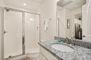 a bathroom with a sink and a toilet and a shower at Queen Suite @ 400 Ocean Suites in Golf Retreat