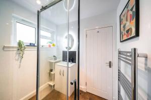 a bathroom with a shower and a glass door at Westland Shores - An East Neuk Gem in Crail