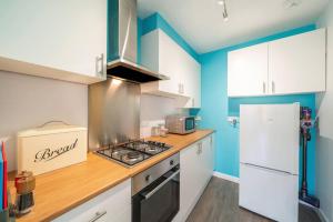 a kitchen with a stove and a refrigerator at Westland Shores - An East Neuk Gem in Crail