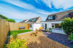 a backyard of a home with a fence at Westland Shores - An East Neuk Gem in Crail +45 photos