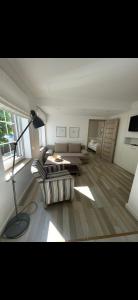 a living room with a lamp and a couch at Apartament Plaza in Rowy