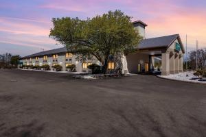 a large building with a tree in the parking lot at Quality Inn Austintown-Youngstown West in Youngstown