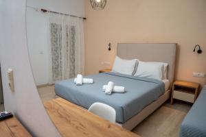 a bedroom with a bed with two towels on it at Achilleas Hotel in Parga