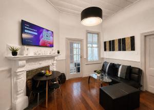 a living room with a couch and a fireplace at CitiRooms Auckland in Auckland