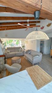 a living room with couches and a ceiling at Casa Palmerita a 7 minutos andando de una playa de aguas cristalinas in Teulada +21 photos