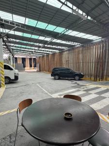 a table and chairs in a parking lot with a car at Regency Sunset Condotel in Angeles +23 photos