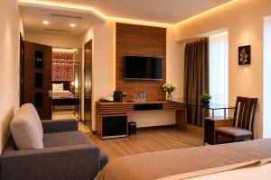 a hotel room with a bed and a desk with a television at Hotel Gareji Kakheti in Sagarejo