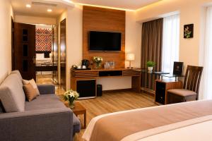 a hotel room with a bed and a television at Hotel Gareji Kakheti in Sagarejo
