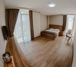 a bedroom with a bed and a large window at Karasu Riva Otel in Karasu