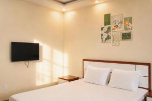 a bedroom with a bed and a flat screen tv at Cat Ba Sky Home in Cat Ba +17 photos