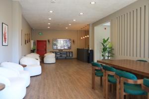 a living room with white chairs and a table at Karasu Riva Otel in Karasu