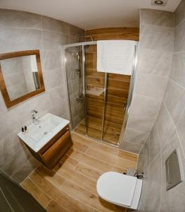 a bathroom with a toilet and a sink and a shower at Karasu Riva Otel in Karasu +11 photos