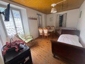 a bedroom with a bed and a table and chairs at Villa Coppa Hotel in Dazio