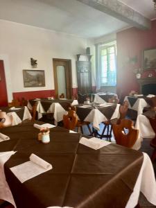 a dining room with tables and chairs in a restaurant at Villa Coppa Hotel in Dazio