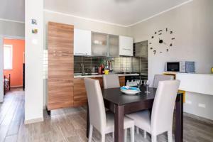 a kitchen and dining room with a table and chairs at Domus Bolsena in Bolsena