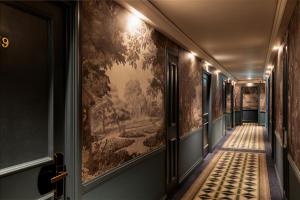 a hallway with a painting on the wall at The Capital Hotel, Apartments & Townhouse - Small Luxury Hotels of The World in London
