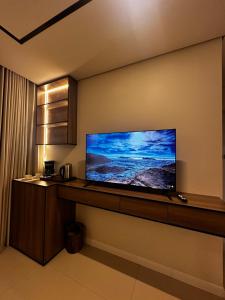 a flat screen tv on a wall in a room at Dara in Al Khobar