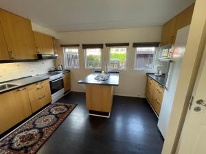 a kitchen with a island in the middle of it at Family home in Greve +16 photos