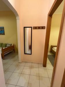 a hallway with a mirror on a wall at Irene's Sunny apartment in Limnos in Néa Koútali