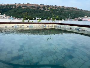 a swimming pool with a view of a city at The Seven Suites - Fort View in Chittaurgarh