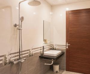 a bathroom with a sink and a mirror and a shower at Cat Ba Sky Home in Cat Ba