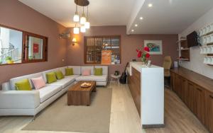 a living room with a couch and a table at Achilleas Hotel in Parga
