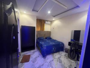a bedroom with a bed and a flat screen tv at Etsuko hotel and suites world city in Atan