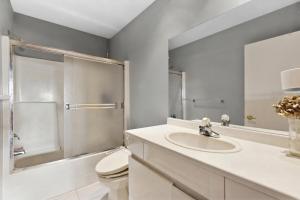 a bathroom with a sink and a toilet and a mirror at Vancouver sea view Palace inn in West Vancouver