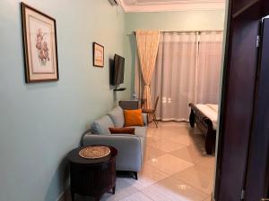 a living room with a couch and a bed at Lakepoint Villa in Entebbe