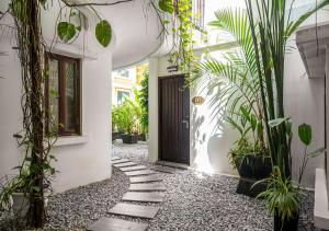 a front door of a house with plants at Faifo Boutique Hotel & Spa in Thanh Ðông (1) +35 photos