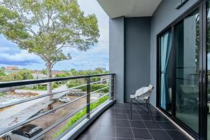 a balcony with a bench and a view at Aster Canopy Suites & Living in Rayong