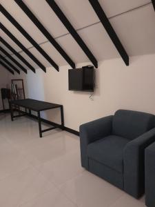 a living room with a couch and a table at Green Luxe in Dambulla