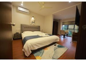a bedroom with a large bed in a room at Kanak Residency Kuthuparamba in Kottayam