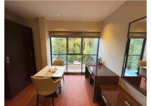 a dining room with a table and a large window at Kanak Residency Kuthuparamba in Kottayam